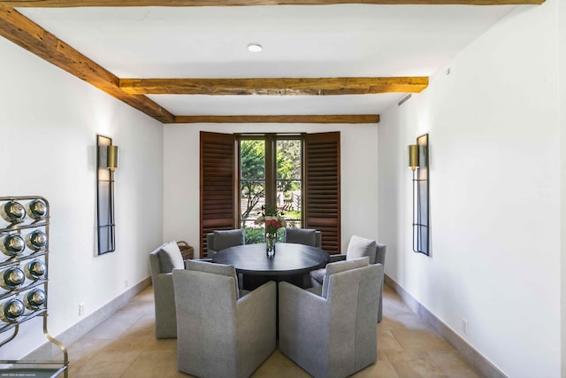 dining space with beamed ceiling