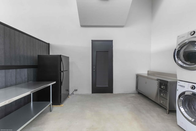 clothes washing area with stacked washer and dryer