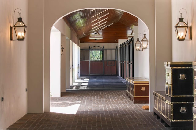 hall featuring lofted ceiling and wood ceiling