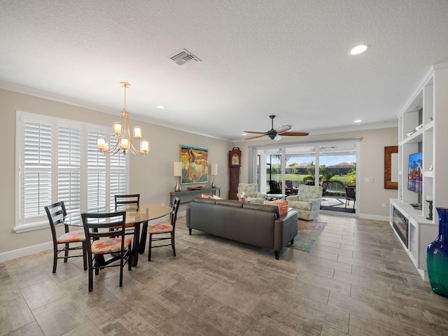 living room with crown molding, ceiling fan with notable chandelier, and a textured ceiling