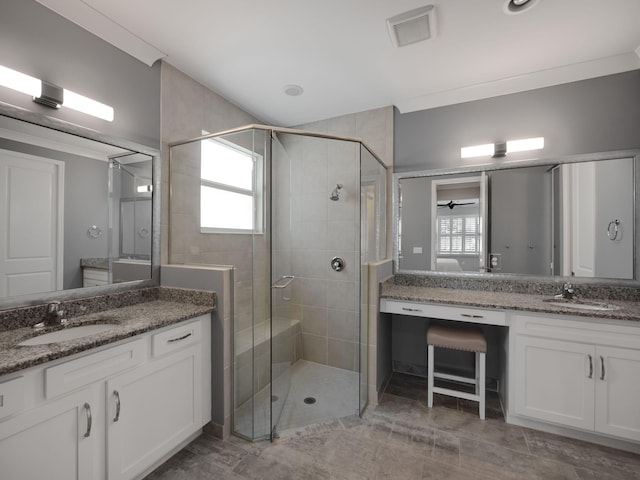 bathroom featuring vanity, crown molding, and a shower with door