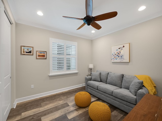 living room with ceiling fan, ornamental molding, and dark hardwood / wood-style flooring