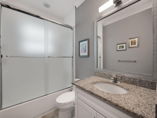 full bathroom featuring vanity, enclosed tub / shower combo, and toilet