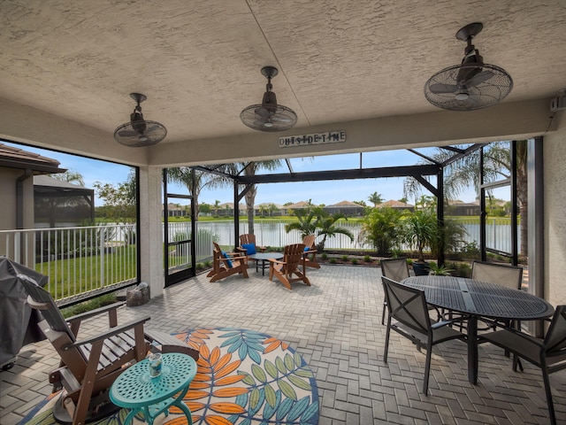 sunroom / solarium with a water view