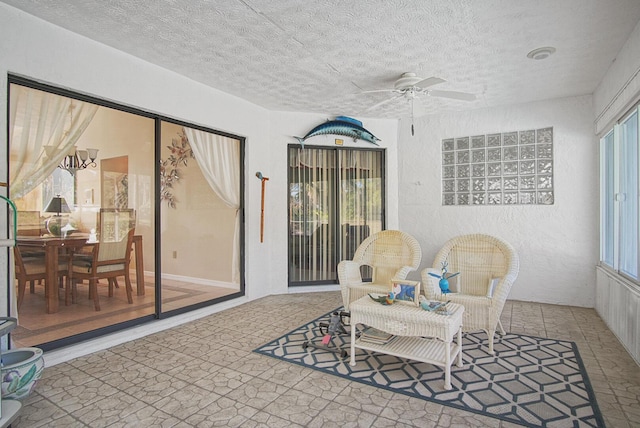 interior space with ceiling fan