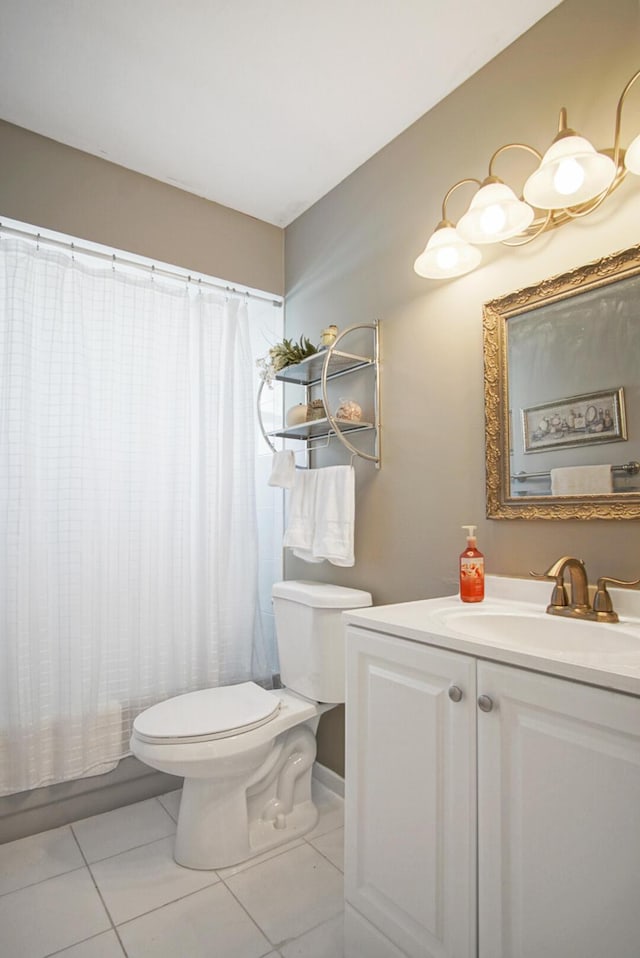 bathroom with tile patterned flooring, vanity, and toilet