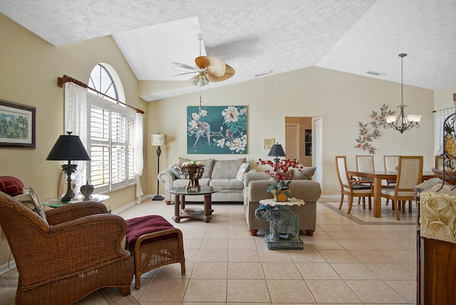 tiled living room with lofted ceiling, ceiling fan with notable chandelier, and a textured ceiling