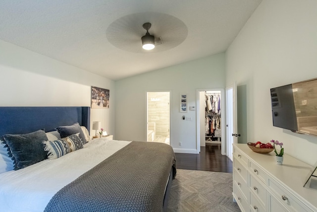 bedroom with lofted ceiling, ceiling fan, ensuite bathroom, a spacious closet, and a closet