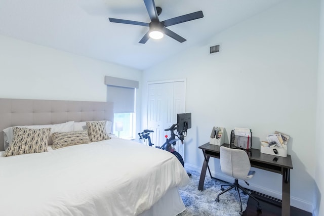 carpeted bedroom featuring ceiling fan, vaulted ceiling, and a closet