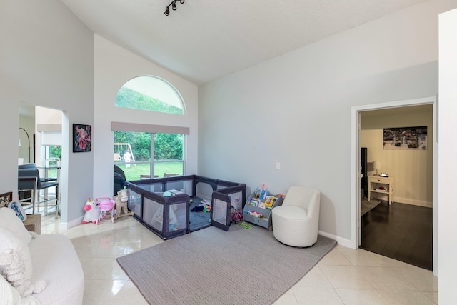 tiled living room with high vaulted ceiling