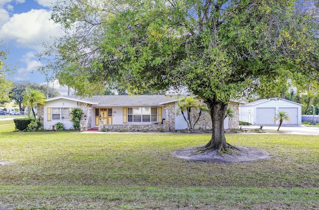 ranch-style house with a garage, an outbuilding, a front yard, and a porch