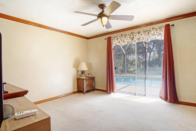 living area with ceiling fan, ornamental molding, and carpet flooring