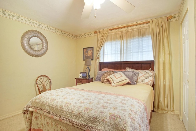 bedroom with light colored carpet and ceiling fan