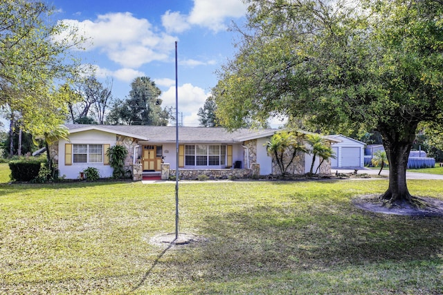 ranch-style house featuring an outbuilding, a garage, and a front lawn