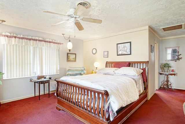 carpeted bedroom featuring a textured ceiling, ornamental molding, and ceiling fan