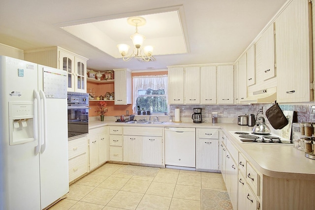 kitchen featuring pendant lighting, sink, light tile patterned floors, a notable chandelier, and white appliances