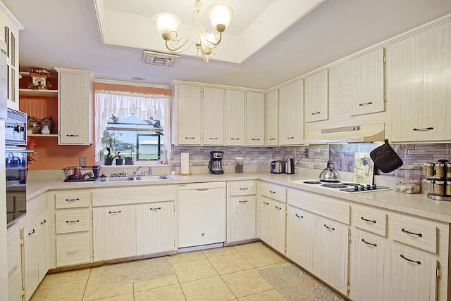 kitchen featuring light tile patterned floors, white appliances, sink, a notable chandelier, and decorative backsplash