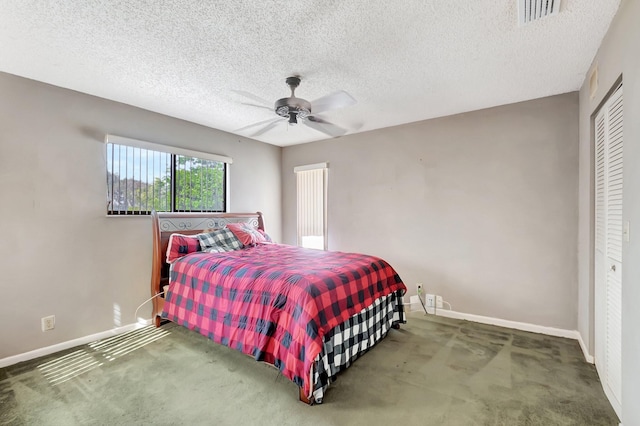 carpeted bedroom featuring ceiling fan, a closet, and a textured ceiling