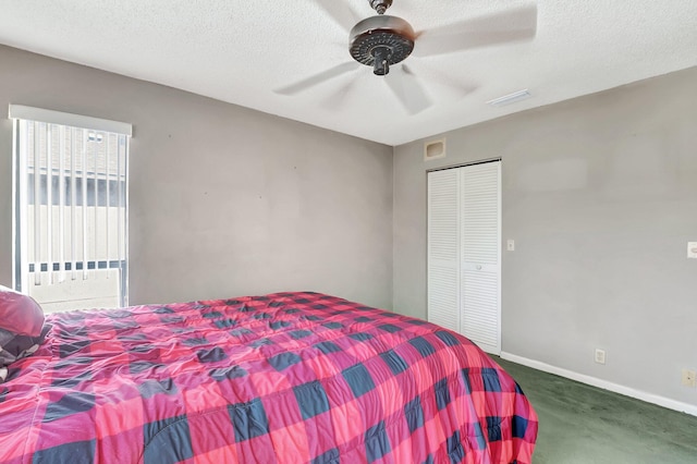 carpeted bedroom with ceiling fan, a closet, and a textured ceiling