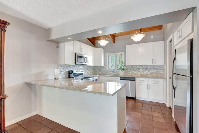 kitchen featuring white cabinetry, backsplash, stainless steel appliances, and kitchen peninsula