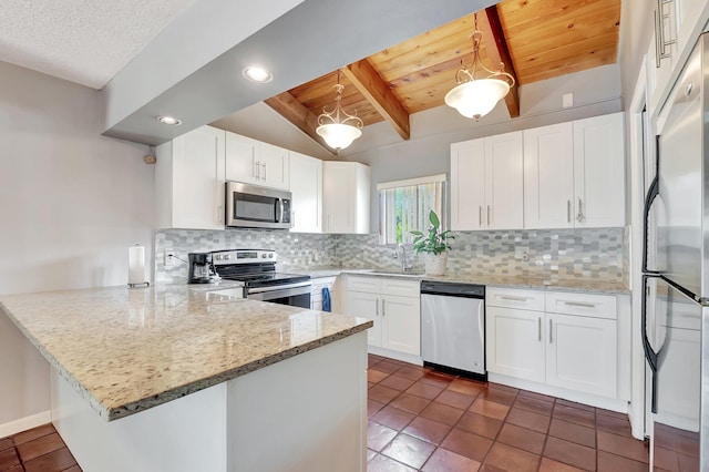 kitchen featuring white cabinetry, hanging light fixtures, light stone counters, kitchen peninsula, and stainless steel appliances