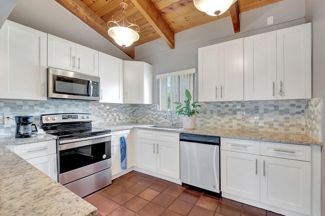 kitchen featuring sink, stainless steel appliances, tasteful backsplash, light stone counters, and white cabinets