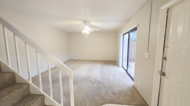 interior space featuring ceiling fan and a textured ceiling