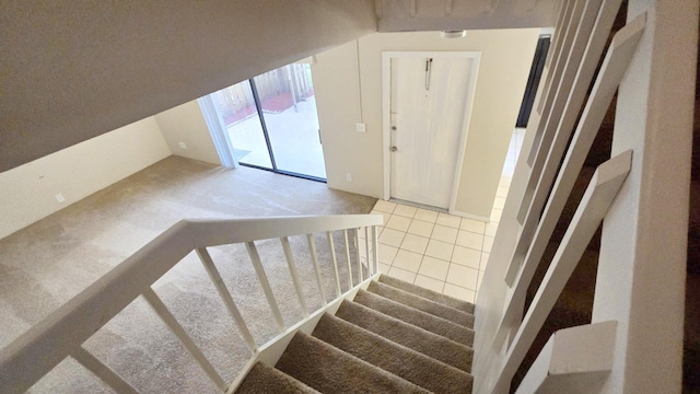 stairway featuring carpet flooring