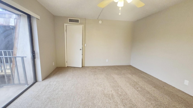 carpeted spare room with ceiling fan