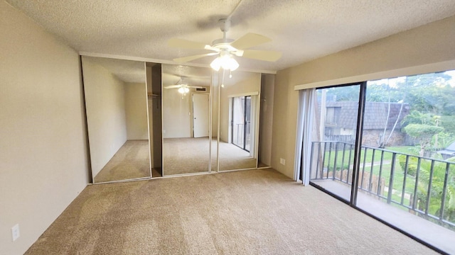 unfurnished bedroom featuring light carpet, a textured ceiling, access to outside, and ceiling fan