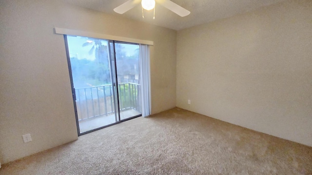 spare room with carpet floors and ceiling fan