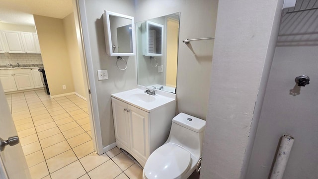 bathroom with vanity, decorative backsplash, tile patterned floors, and toilet