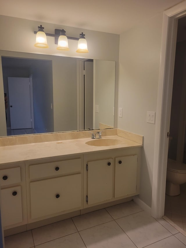 bathroom with vanity, toilet, and tile patterned flooring