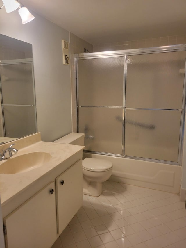 full bathroom with toilet, tile patterned floors, bath / shower combo with glass door, and vanity