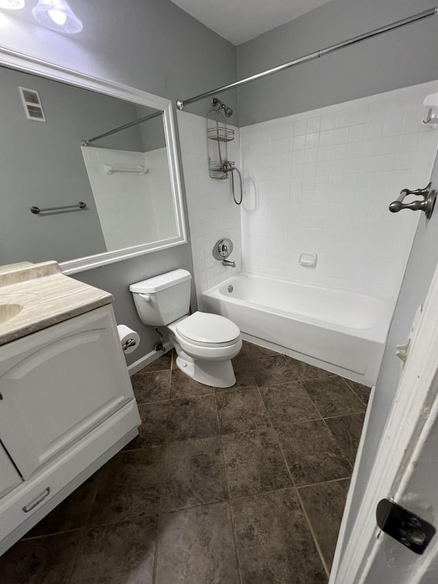 full bathroom with vanity, tiled shower / bath combo, and toilet