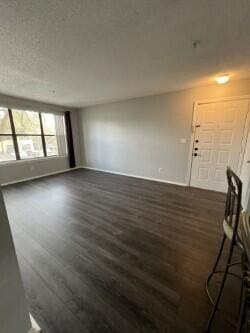 unfurnished living room featuring dark wood-type flooring