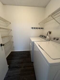 clothes washing area featuring dark wood-type flooring and independent washer and dryer