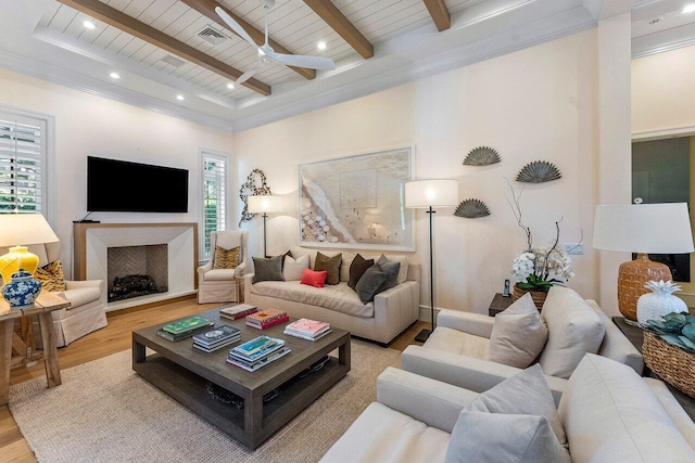 living room featuring beamed ceiling, ceiling fan, wood ceiling, and light hardwood / wood-style floors