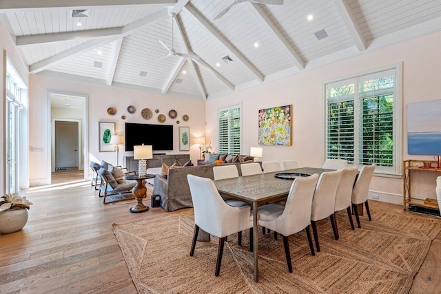 dining room with high vaulted ceiling, wood ceiling, light hardwood / wood-style floors, and beamed ceiling