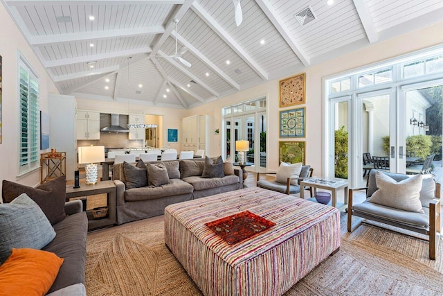 living room with french doors, high vaulted ceiling, and beamed ceiling