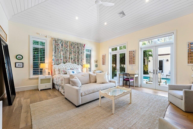 bedroom with lofted ceiling, access to outside, wooden ceiling, french doors, and light wood-type flooring