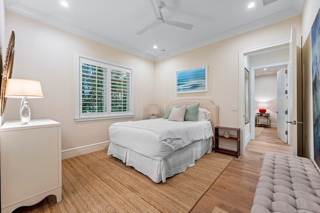 bedroom with ceiling fan, ornamental molding, and light wood-type flooring