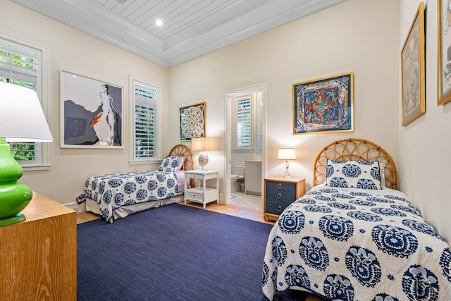 bedroom featuring ornamental molding and connected bathroom