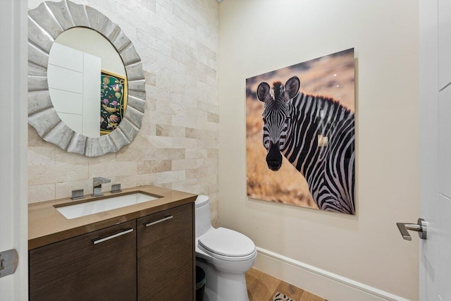 bathroom featuring vanity, toilet, and hardwood / wood-style floors