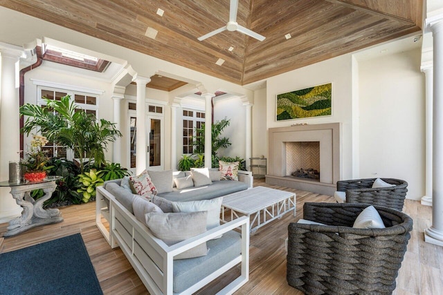 sunroom / solarium featuring ornate columns, lofted ceiling, wooden ceiling, and ceiling fan