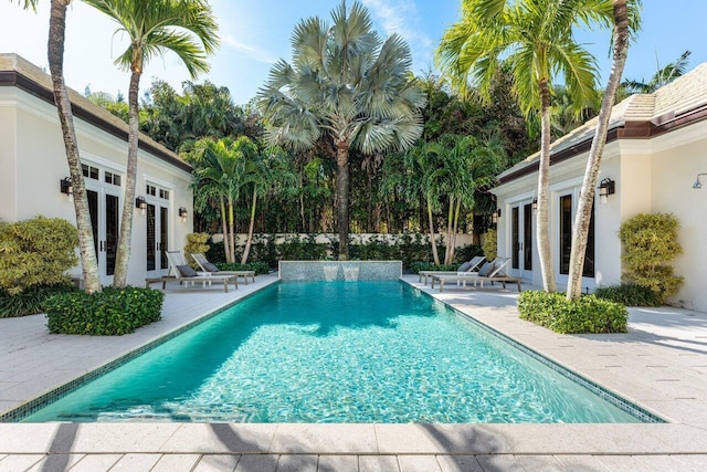 view of pool with a patio and french doors