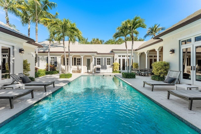 view of swimming pool with a patio area and french doors