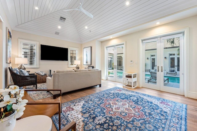 living room featuring ceiling fan, light hardwood / wood-style floors, vaulted ceiling, wooden ceiling, and french doors