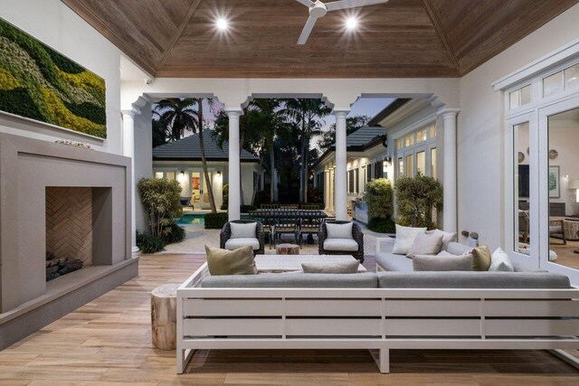 view of patio with a gazebo, ceiling fan, and an outdoor living space with a fireplace