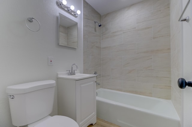 full bathroom featuring vanity, toilet, and tiled shower / bath combo